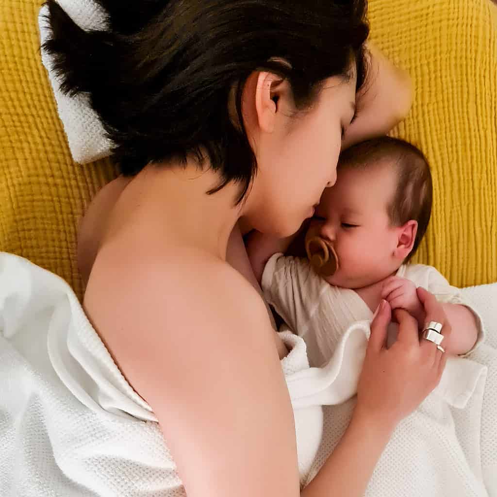 mum and baby lying on massage couch